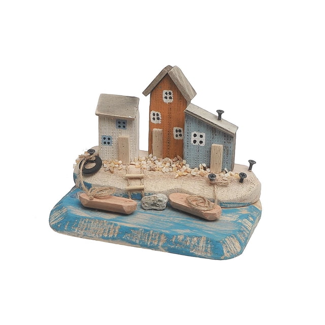 Wooden Triple Nautical House Decor showing three small wooden houses in white, orange, and blue with painted window and door details, set on a sandy base with small pebbles and two wooden boats tied with rope on a blue base representing water, ideal for coastal-themed tabletop decoration.