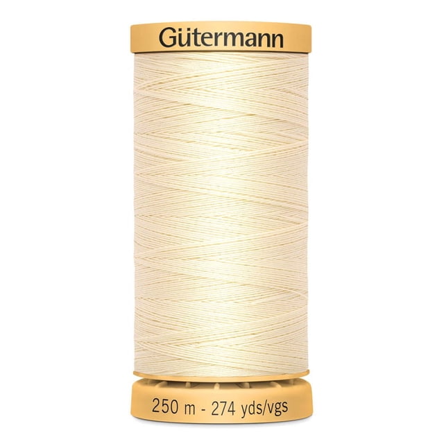 Gütermann cotton thread spool in natural cream colour, 250 meters (274 yards), tightly wound on a beige plastic bobbin with brand name on top and length details on the base, ideal for sewing notions and machine or hand stitching projects.