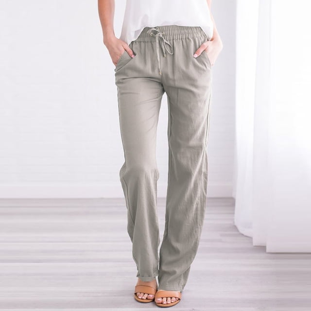 CEHVOM Women Casual Cotton And Linen Solid Drawstring Elastic Waist Long Straight Pants in grey. These full-length pants feature a relaxed fit with an elastic waistband and drawstring closure for adjustable comfort. Made from a cotton and linen blend, they are lightweight and suitable for casual, daily, or beachwear. The pants include side pockets and a straight-leg design, styled here with a white top and sandals in a bright indoor setting.