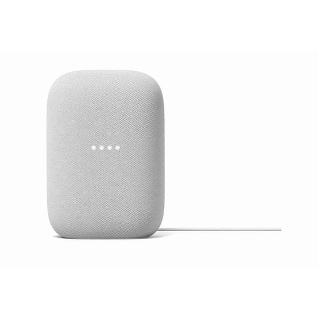 Google Nest Audio smart speaker in sand colour with rounded rectangular fabric mesh design, four white LED lights on front, and power cord extending from the back on a white background, ideal for voice-controlled smart home audio.