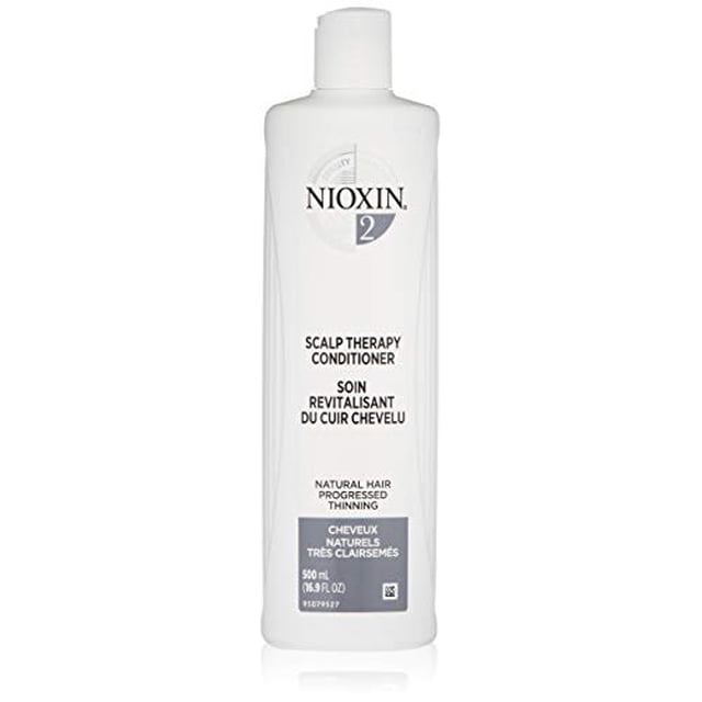 Nioxin System 2 Scalp Therapy Conditioner, 16.9 oz bottle, designed for natural hair with progressed thinning. Features BioAMP technology to strengthen and moisturize hair, leaving it fuller-looking. The white bottle includes bilingual labeling in English and French, with a focus on scalp health and hair resilience.