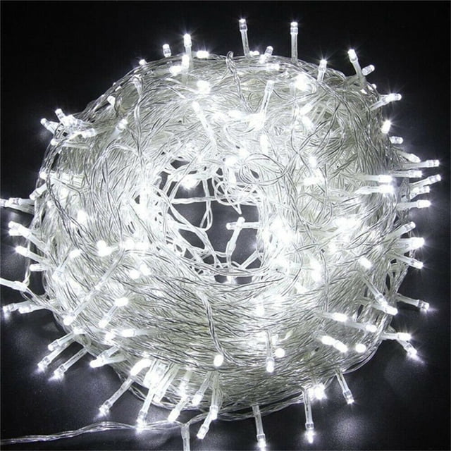 EGNMCR Light Strip, Christmas Lights - String Lights 100 LED Christmas Tree Wedding Party Decor Outdoor String Light. A coiled 10-meter string of 100 bright white LED lights with a transparent cable, designed for indoor and outdoor use. Features include eight lighting modes such as twinkle, fade, and flash, making it ideal for decorating Christmas trees, weddings, parties, and other festive occasions. The lights are energy-efficient, waterproof, and customizable for various settings.
