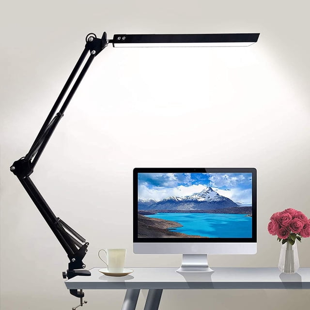 Staron Desk Lamp under $5! LED Clamp Light with 3 Colors and 10 Brightness levels, clamped to a desk. The lamp has a black swivel arm design with adjustable angles, ideal for office or study task lighting. The desk setup includes a computer monitor, a cup, and a vase of pink roses, highlighting its functionality in workspaces.