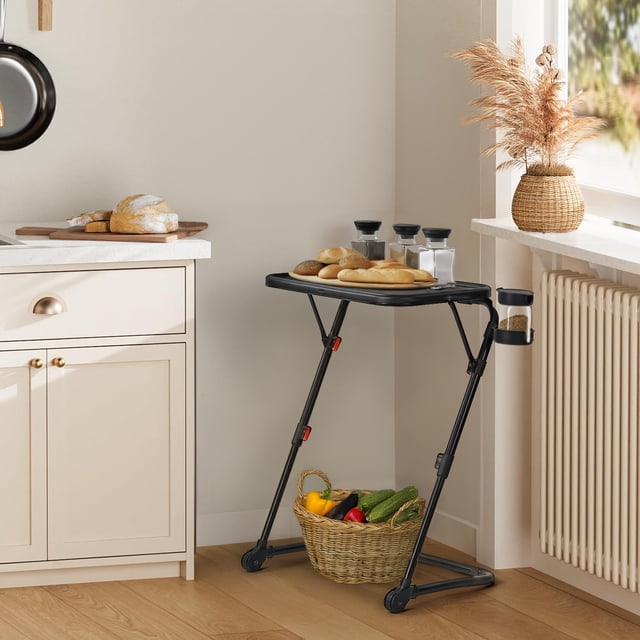 Black matte portable folding utility cart with fixed cup slot, displaying bread and spice jars in a kitchen setting.