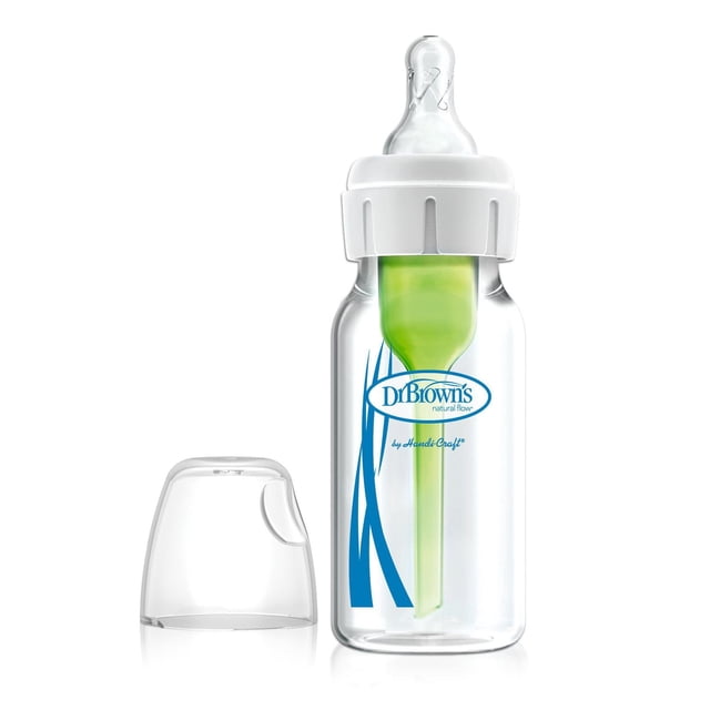 Dr. Brown's Options Anti-Coliques à Débit Naturel+ Biberon Étroit en Verre pour Bébé 4 oz/120 ml avec Tétine à Débit Lent Niveau 1, Bouteille en Verre Transparente avec Bouchon à Vis Blanc et Tétine en silicone Transparente, avec Système d'Évent Interne Vert à l'Intérieur, logo Dr. Brown's Bleu à l'Avant, et un Capuchon Protecteur transparent à Côté sur Fond Blanc.