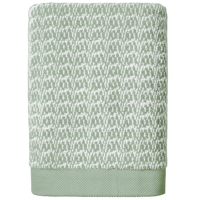 Better Homes & Gardens Signature Soft Melange Bath Towel folded showing a green and white textured melange pattern with a solid green border, made of 90% US cotton and 10% viscose, super absorbent, fade resistant, and engineered with PureLOFT® technology for softness and durability, suitable for kids' bathroom use.