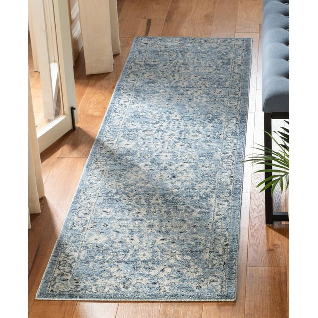 SAFAVIEH Charleston Tangier Overdyed Floral Area Rug 2'x8' runner featuring a traditional floral pattern in muted blue and cream, power loomed with synthetic yarns, placed on hardwood flooring near a window and a grey tufted bench, suitable for hallways or entryways.