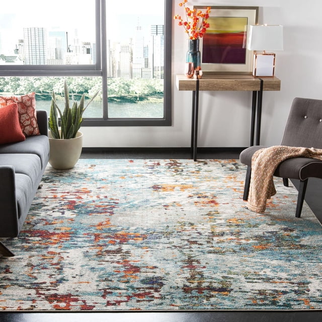 Safavieh Madison Tapis Vintage Abstrait à Motifs Floraux Multicolores en Tons Bleu, orange et beige, Tissé Mécaniquement pour la Durabilité. Exposé dans un Salon avec un sofa Gris, des Coussins Rouges, une Plante Serpent en Pot, une table console en Bois avec des Fleurs orange et des Oeuvres d'Art, et une Chaise Grise avec un Jeté beige, Idéal pour une Déco Moderne et Transitionnelle.
