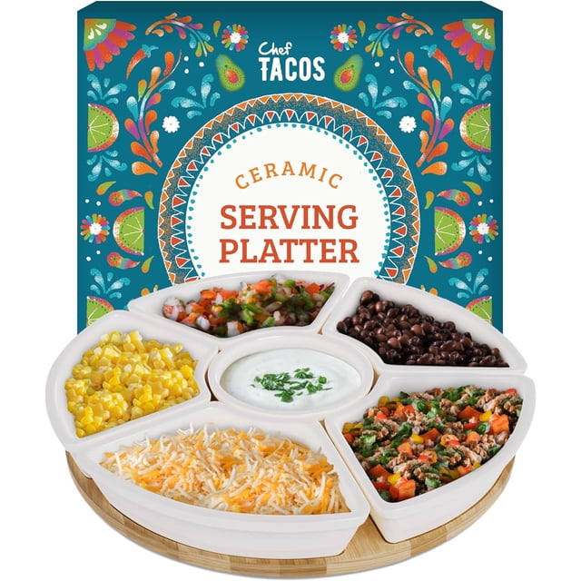 Chef Tacos Ceramic Taco Serving Platter, a divided white ceramic tray with six sections, including a central dip compartment, shown with taco toppings like cheese, beans, salsa, and corn. The tray rests on a wooden Lazy Susan base, perfect for Taco Tuesday or entertaining. The festive packaging with colourful patterns is visible in the background.