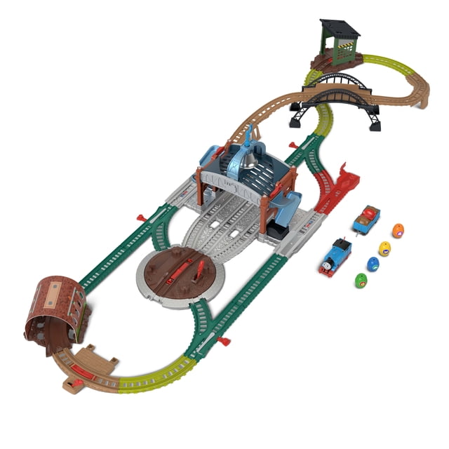 Thomas & Friends Load & Launch Barrel Delivery Set by Fisher-Price with motorized Classic Thomas engine and cargo car on 18-foot multicolored track featuring a turntable, bridge, tunnel, delivery warehouse, four barrels, and a bell that rings when barrels launch for interactive train play.