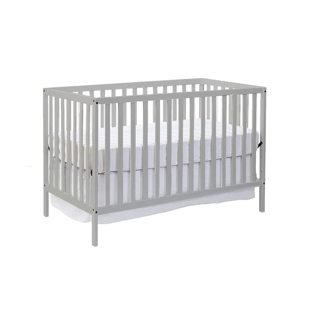 Concord Baby Devon 4-in-1 Crib in grey with solid wood frame and vertical slats, shown from a front 3/4 view with a white mattress set at adjustable mid-height, designed for nursery use and convertible to toddler and full-size beds.