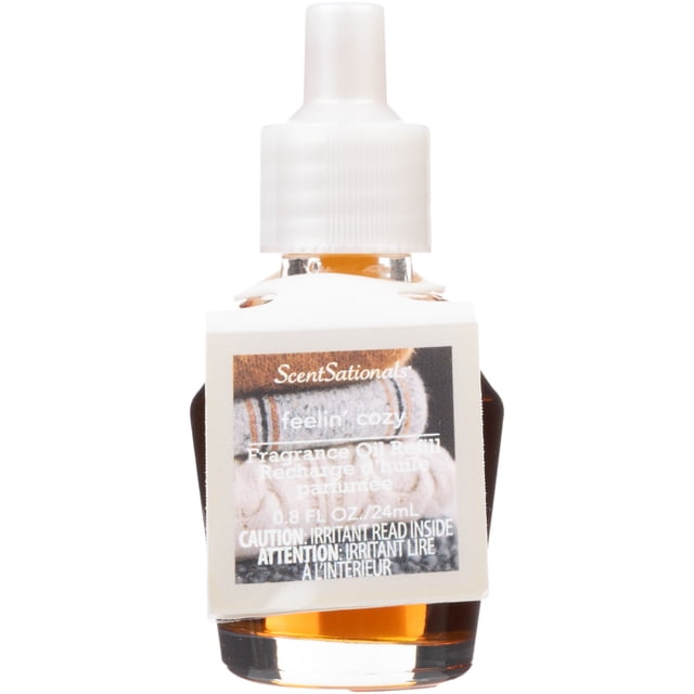 ScentSationals Scent Charm Oil - Feelin' Cozy fragrance oil refill bottle with amber liquid and white plastic cap, designed for use with ScentSationals air freshener diffusers to provide long-lasting home fragrance and create a warm, inviting atmosphere.