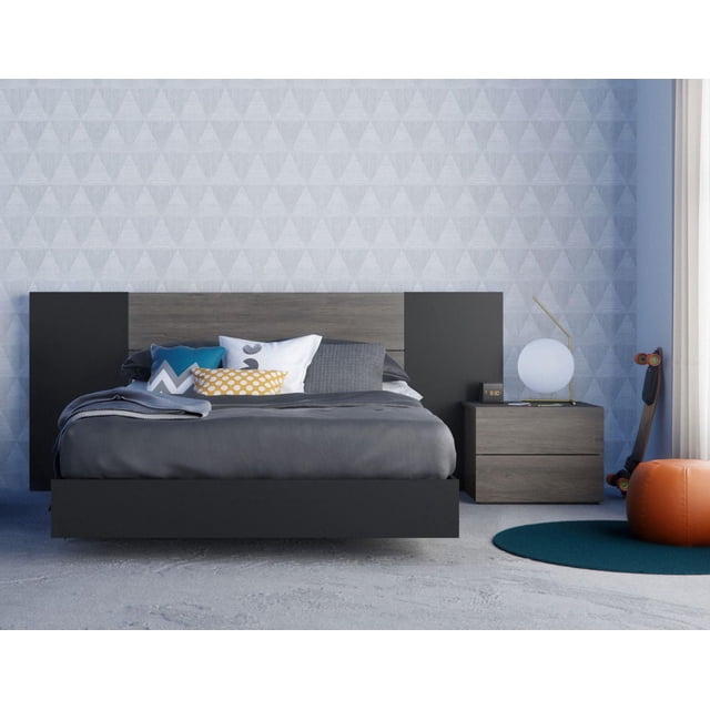 Sinatra 4 Piece Bedroom Set, Bark Grey and Black featuring a floating bed with bark grey and black finish, rustic plank-effect headboard, and matching two-drawer nightstand with spherical lamp and digital clock, in a minimalist room with geometric wallpaper, skateboard, and orange pouf.