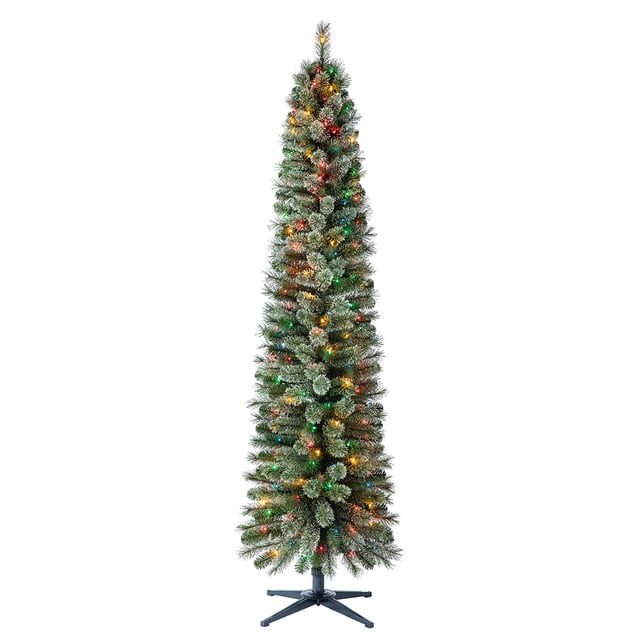 Home Heritage Stanley 7' Pine Artificial Christmas Tree, PreLit 350 Color Lights. A slim, pencil-shaped tree standing 7 feet tall with 335 lush green foliage tips and pre-lit with 350 multi-colored incandescent lights. Features a sturdy metal stand and compact dimensions of 22 inches wide, ideal for holiday decor in smaller spaces or apartments.