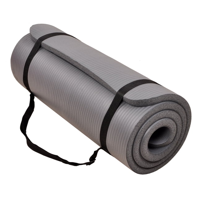Signature Fitness 1-inch extra thick exercise yoga mat in gray, featuring high-density foam for optimal comfort and support. The mat measures 71 inches long and 24 inches wide, suitable for various exercises like yoga, Pilates, and home workouts. It has a double-sided non-slip surface for stability, an anti-tear design for durability, and resistance to moisture for easy cleaning. Includes an integrated carry strap for portability and storage.