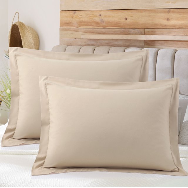 PiccoCasa Soft 1800 Microfiber Oxford Pillowcases 2Pcs, Standard Tan. A pair of tan pillow shams made from 1800 series brushed microfiber, featuring an envelope closure design to keep pillows secure. Each pillowcase measures 20 x 26 inches and is displayed on a neatly made bed with a wooden headboard in the background. The material is soft, breathable, and machine washable for easy care.