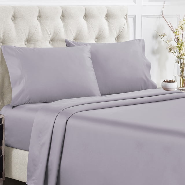 California Design Den Sheet Sets in lavender gray, made from natural 100% cotton with a soft luxury 400 thread count sateen weave. These cooling sheets include a flat sheet, fitted sheet with deep pockets, and two pillowcases, displayed on a tufted beige headboard bed in a bright, elegant bedroom setting.