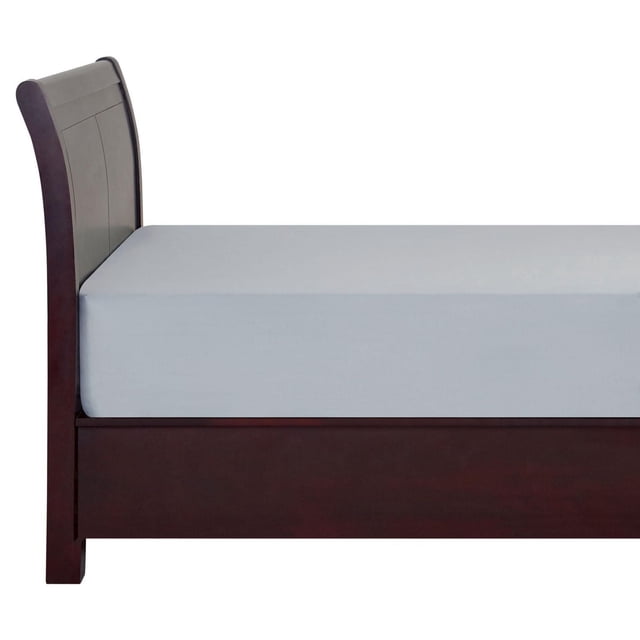 Mainstays fitted sheet in light grey made from breathable 100% cotton with 180 thread count, fitted snugly on a mattress on a dark wood bed frame with curved headboard, designed to fit mattresses up to 12 inches deep and enhance bedroom décor.