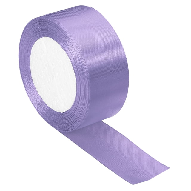 Unique Bargains 1.5-inch wide satin craft ribbon roll in light purple, measuring 24 yards in length. Made of polyester with a smooth, soft texture, perfect for decorative purposes such as gift wrapping, flower arrangements, DIY sewing, and art projects. The single-sided ribbon is packed in a roll for convenient storage and easy cutting.