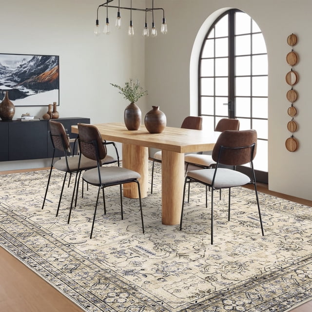 Hasoo 9' x 12' Vintage Indoor Rug for Living Room, a beige floral area rug with distressed medallions, designed for modern and bohemian spaces. Featured in a dining room with wooden furniture, it has a non-slip TPR backing for stability on hardwood floors. This stain-resistant, machine-washable accent rug is versatile for bedrooms, entryways, or under a fireplace.