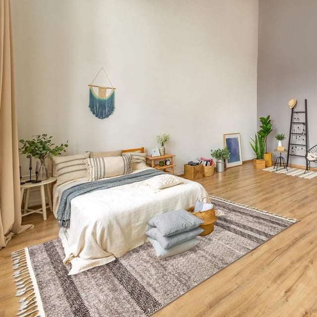 ECARPET Southwestern Rug for Hallway, Kitchen Coastal Collection in grey with non-slip backing, placed on a light wood floor under a queen bed with cream bedding and blue throw, accented by minimalist plants, baskets, and wall art, ideal for high-traffic indoor spaces.
