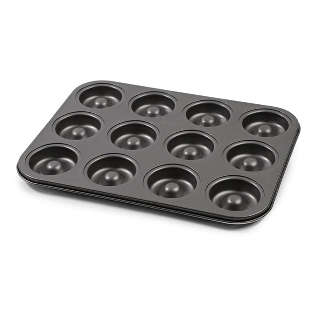 Pillsbury 12 cup donut pan in grey high carbon steel with nonstick coating, featuring 12 cavities for baking mini donuts, bagels, muffins, or brownies evenly. The BPA and PFOA free pan is dishwasher safe and shown at a 3/4 angle on a white background.