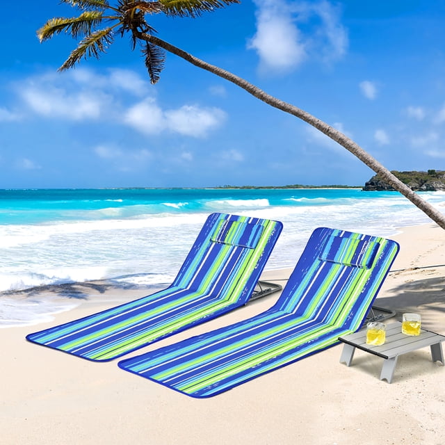 Costway 3-Piece Beach Lounge Chair Mat Set with two portable adjustable lounge chairs in striped waterproof oxford fabric and a lightweight folding table, set on a sunny beach with palm trees and ocean waves. The chairs feature removable headrests, adjustable backrests, and a zippered storage bag, while the table holds two drinks.
