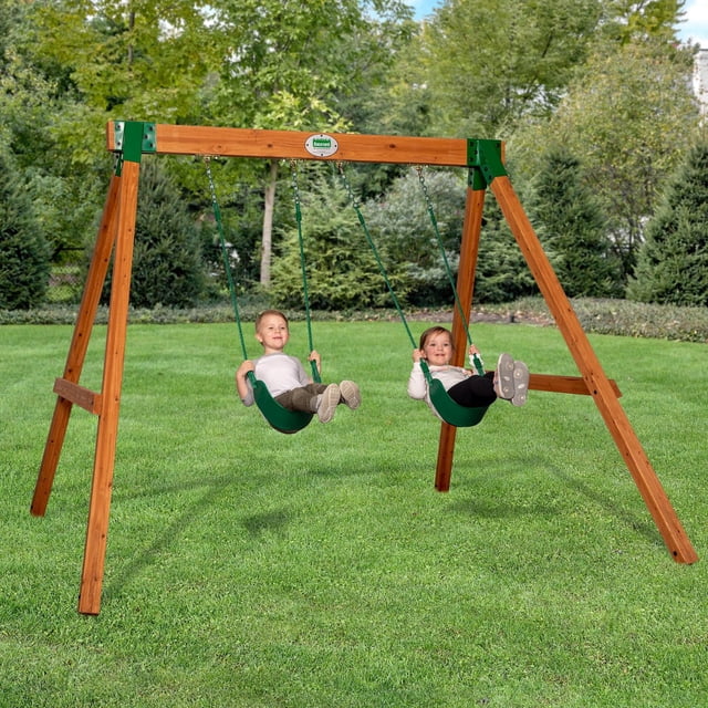 Backyard Discovery Durango Swing Set with heavy-duty cedar wood A-frame and green steel corner supports, featuring two wide green belt swings on a grassy lawn with trees in the background, designed for safe and stable outdoor play.