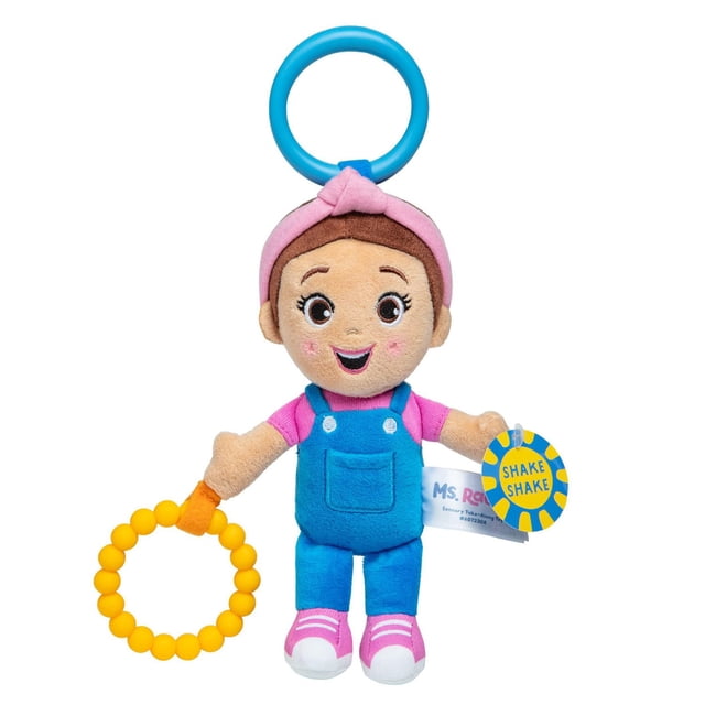 Ms. Rachel Official Sensory Take-Along Toy, a plush doll wearing blue overalls and a pink shirt with a pink headband, holding a yellow teething ring and a blue clip ring, designed with crinkly textures and a rattle to promote sensory and motor skills in babies 0-1+.