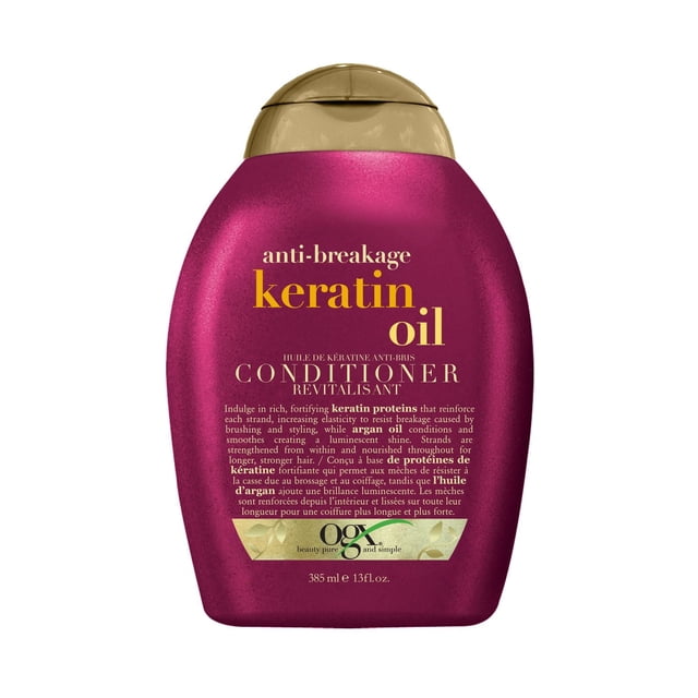 OGX Anti-Breakage + Keratin Oil Conditioner in a 385 ml (13 fl oz) magenta bottle with a gold flip-top cap, formulated with keratin proteins and argan oil to strengthen and nourish hair, reduce breakage, and promote longer, stronger strands, ideal for maintaining healthy hair.