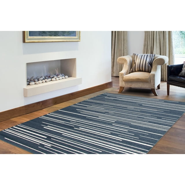 Minimalist striped area rug from ECARPET Fika Collection placed on wooden floor near beige armchair and modern fireplace.