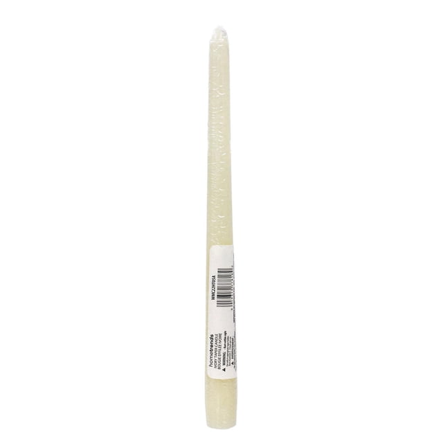 Hometrends 10 inch ivory unscented taper candle with cotton wick, wrapped in clear plastic with a white label showing barcode and brand details, standing upright on a white background, suitable for home décor and events.
