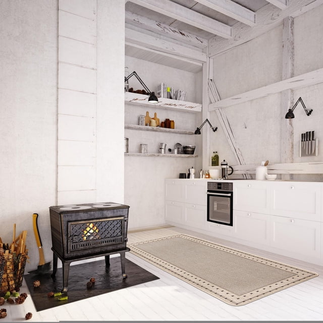 ECARPET Kitchen, Hallway, Laundry Room, Entrance, Kids Room, Bathroom Mat & Utility Rug, Non Slip Rubber Backing shown in a rustic kitchen with white wooden floors and exposed beams, featuring a rectangular jute-style runner rug with geometric border on the floor near a black cast iron wood stove with fire, white cabinetry with built-in oven, open shelves with kitchenware, and wall-mounted knife rack.