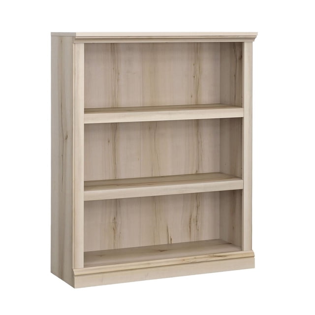 Sauder Select 3-Shelf Bookcase in light wood finish with a rectangular frame, two adjustable shelves supporting up to 25 lbs each, and a solid back panel, designed for multi-room storage with included wall anchor kit for safety.