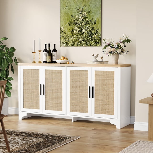 4-Door Sideboard Buffet Cabinet with a natural rattan design and white frame, featuring four spacious compartments and a sturdy wooden top. This boho-style storage cabinet is shown in a cozy dining room setting with decor items like wine bottles, candles, and flowers displayed on the tabletop. Ideal for use as an entryway console table, farmhouse coffee bar station, or kitchen pantry.