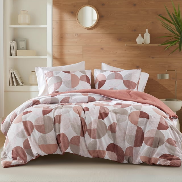 Regency Heights Full/Queen Size Comforter Set featuring a terracotta round geometric print. Includes a 90-inch by 90-inch comforter and two 20-inch by 26-inch standard shams. Made from ultra-soft microfiber, this lightweight and breathable bedding set is Oeko-Tex certified for safety. Ideal for kids' bedding, it is displayed in a modern bedroom with wooden accents and neutral decor.