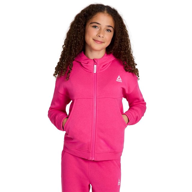 Chandail à Capuchon à Fermeture Éclair Complète pour Filles Reebok Encore en Molleton Mélange de Coton Rose Vif, Coupe Décontractée, Fermeture Éclair avant Complète, Poche Kangourou et logo Reebok Brodé Blanc sur la Poitrine Gauche, Assorti à un Pantalon Rose Assorti, Idéal pour les Tenues Décontractées et Actives.