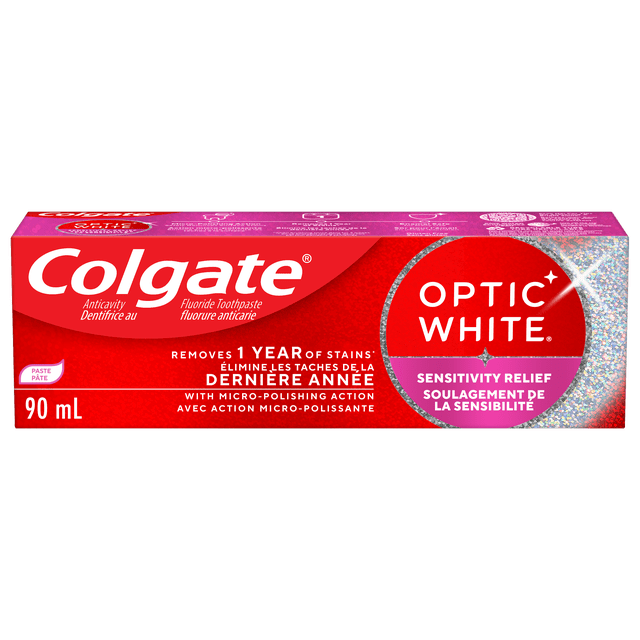 Colgate Optic White Sensitivity Relief Toothpaste 90 mL box in red with silver holographic details, featuring stain removal of 1 year, micro-polishing action for sensitivity protection, enamel safe whitening toothpaste with fluoride, bilingual English and French labeling.