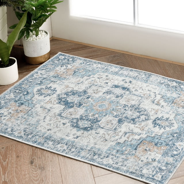 RUGKING Area Rug 2x3 with a vintage blue floral print design, shown in a rectangular shape on a wooden floor near a bright window. The distressed chenille material adds a thin, foldable texture, and the non-slip backing ensures stability. Suitable for indoor use in kitchens, bathrooms, entryways, or living spaces.