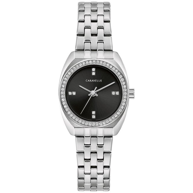 Caravelle Ladies Silver-Tone Quartz Watch with a 26mm stainless steel case and bracelet, black dial featuring crystal markers at 12, 3, 6, and 9 o'clock, and a bezel surrounded by crystals. It has a mineral crystal face, foldover clasp, and is water resistant up to 30 meters, ideal for both everyday wear and formal occasions.