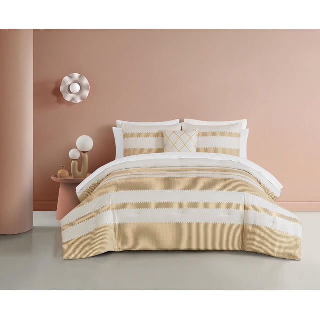 Alina 4 Piece Comforter Set with cream microfiber comforter and two matching shams featuring thick horizontal bands of staggered ochre vertical lines, plus a 16x16 decorative pillow with gold metallic lattice print, displayed on a bed in a soft pink room, designed for warmth and easy machine washing.