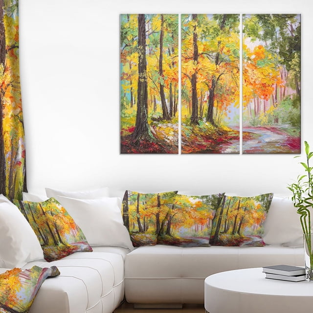 Design Art Impression sur Toile de Forêt Automnale Colorée, Toile en Coton Enveloppée à Trois Panneaux Montrant des Arbres d'Automne Jaunes, orange et Verts Vibrants sur un Sentier Sinueux, Exposée au-Dessus d'Un sofa Sectionnel Blanc avec Coussins Assortis dans un Salon Moderne, Prête à Accrocher avec Quincaillerie Incluse.
