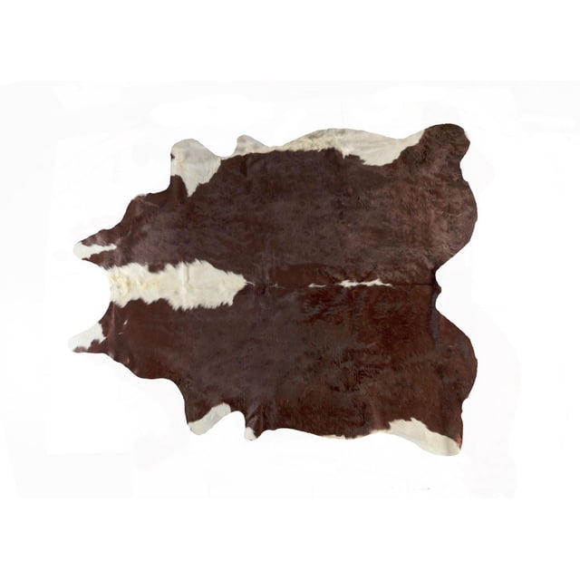 H-Natural Kobe Cowhide 6'X7' Rug laid flat with natural irregular edges, featuring dark brown and white patches, soft low pile texture, and supple sheen, ideal for high-traffic indoor areas and adding warmth to home décor.