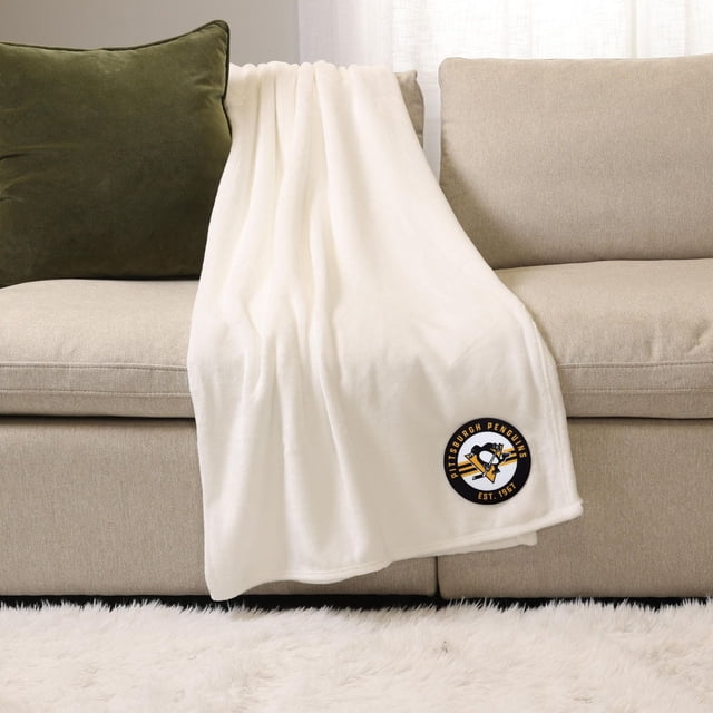 LNH , NBA, Couverture de Sport Blanche MLB, 50 Pouces x 60 Pouces, Drapée sur un sofa beige avec un Oreiller Vert, avec un Écusson logo des Pingouins de Pittsburgh en Noir, Jaune et Blanc sur le Coin Inférieur, Fabriquée en polyester Peluche Doux pour Chaleur et Confort à l'Intérieur.