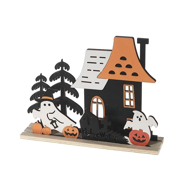 Wood House And Ghost Decor showing a black wooden haunted house with an orange roof and white window details, accompanied by two white ghost figures—one with a witch hat holding a lantern, the other near a carved pumpkin. The display includes black pine trees, small pumpkins, and a black graveyard sign with 'Halloween' text, all mounted on a wooden base, perfect for Halloween tabletop décor.