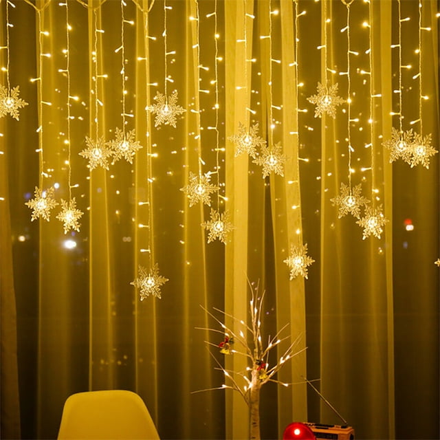 Staron 13ft Christmas Lights with LED snowflake string lights in warm white, displayed indoors against a curtain backdrop. The lights feature 8 lighting modes and are evenly spaced along copper wire, creating a festive ambiance. Ideal for indoor and outdoor holiday, party, wedding, and Christmas tree decorations.