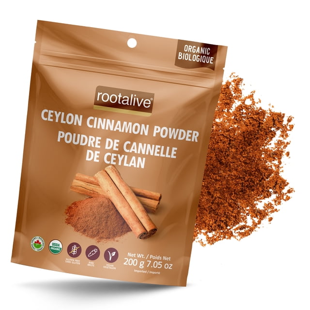 Rootalive Organic Ceylon Cinnamon Powder 200g in a resealable brown pouch with bilingual labeling in English and French. The packaging highlights USDA organic certification, vegan, and gluten-free attributes. Loose cinnamon powder and cinnamon sticks are displayed next to the pouch.