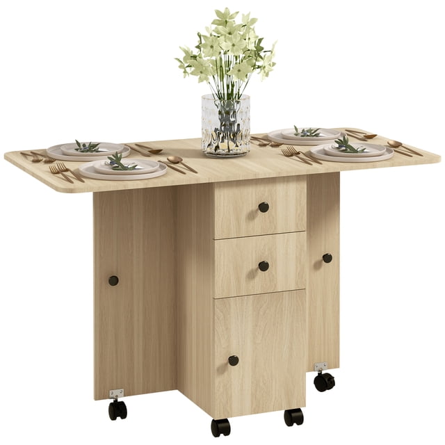 HOMCOM Foldable Dining Table in natural wood with a drop-leaf design, shown fully extended and set for dining with plates, cutlery, and a decorative vase. Features two drawers, a cabinet for storage, and six wheels for mobility, four of which have brakes. Made of particleboard with a melamine top coating for easy cleaning. Ideal for compact spaces, accommodating 4 to 6 people when extended.