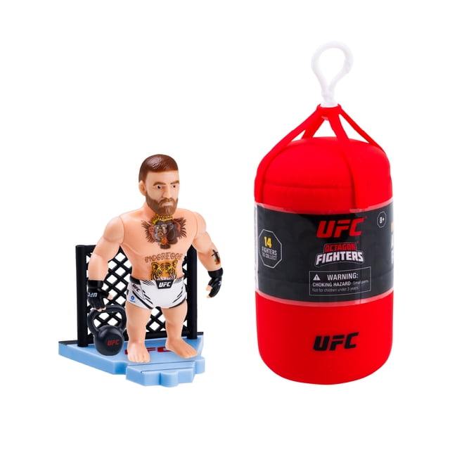UFC 3 Inch Mini Articulated Action Figures Punching Bag front-facing opened capsule revealing a 3-inch articulated surprise fighter on a connecting base, plastic figure with visible glove and shorts texture, collectible sticker and mini-poster included, notes ultra rare golden figures and build-your-Octagon display or desk collectible use.