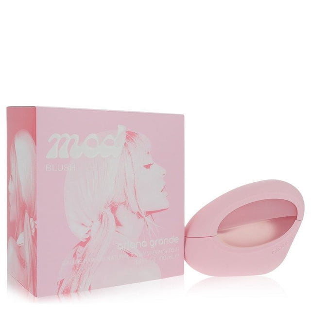 Ariana Grande Mod Blush Eau De Parfum Spray 3.4 oz displayed with its packaging. The perfume bottle features a sleek, oval design in soft pink, complementing the matching box adorned with Ariana Grande's profile and the 'Mod Blush' branding.